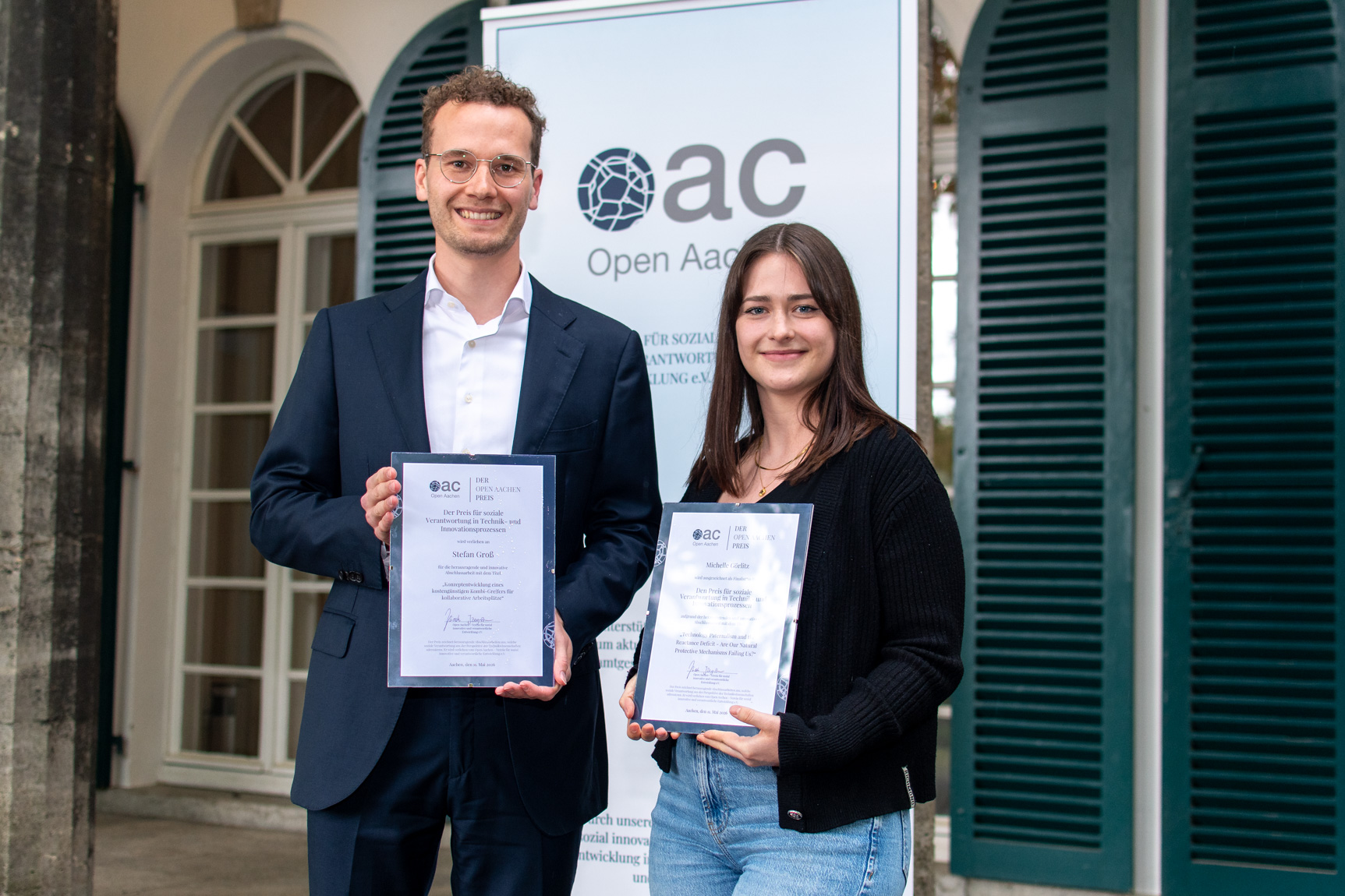 Preisträger Stefan Groß und Finalistin Michelle Görlitz präsentieren ihre Urkunden.